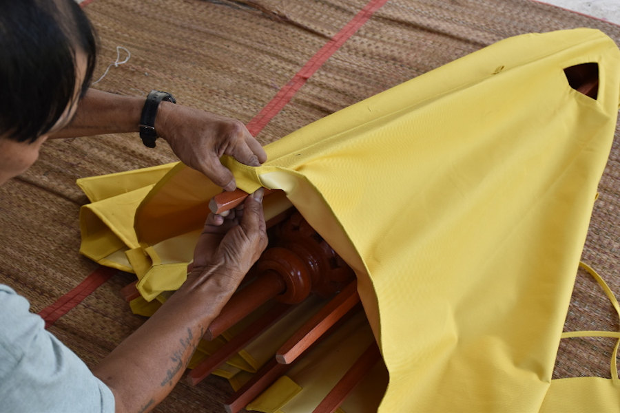 Mounting a new canopy on a heavy duty market umbrella frame.